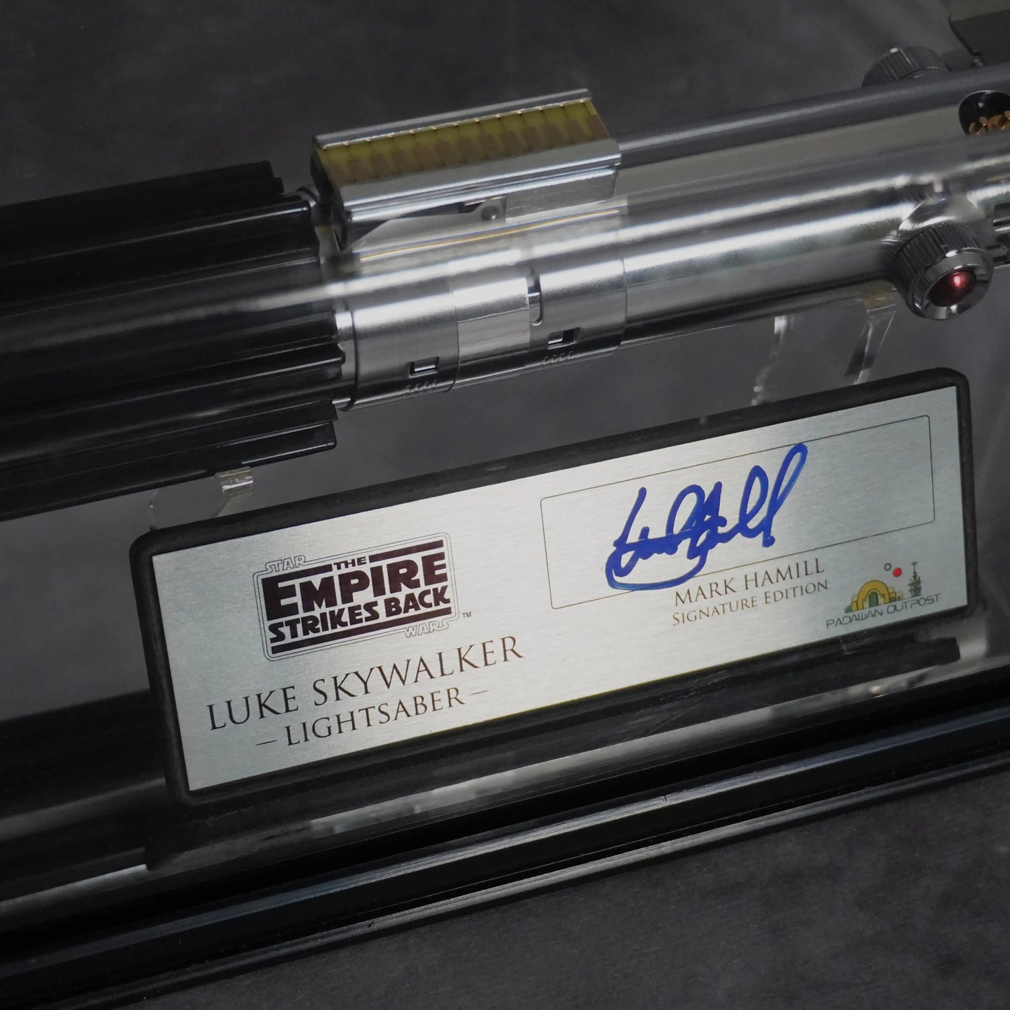 Mark Hamill signature in blue ink on the Empire Strikes Back Luke Skywalker plaque