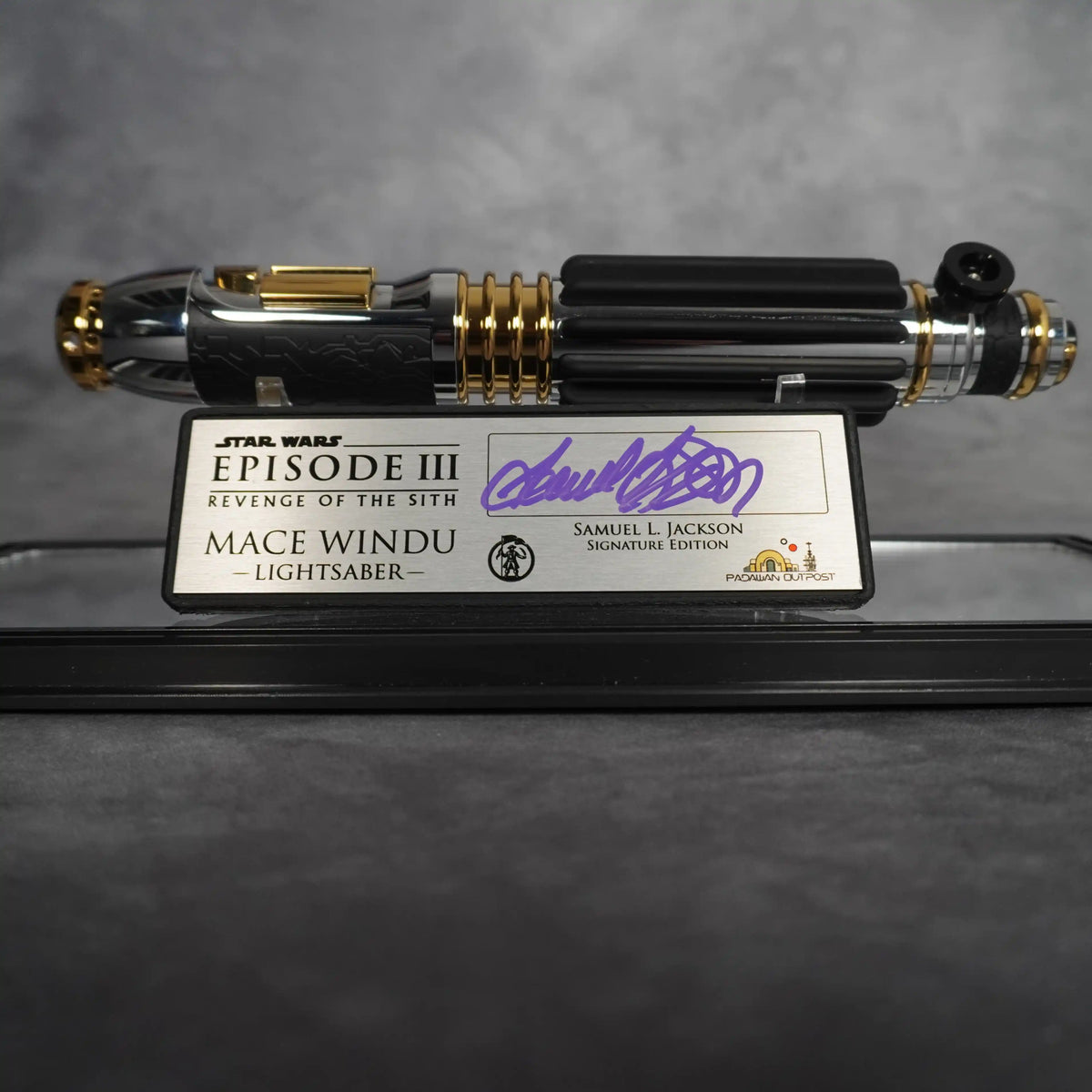 Close-up of the Mace Windu lightsaber hilt and the brushed metal Revenge of the Sith Signature Edition plaque signed by Samuel L. Jackson